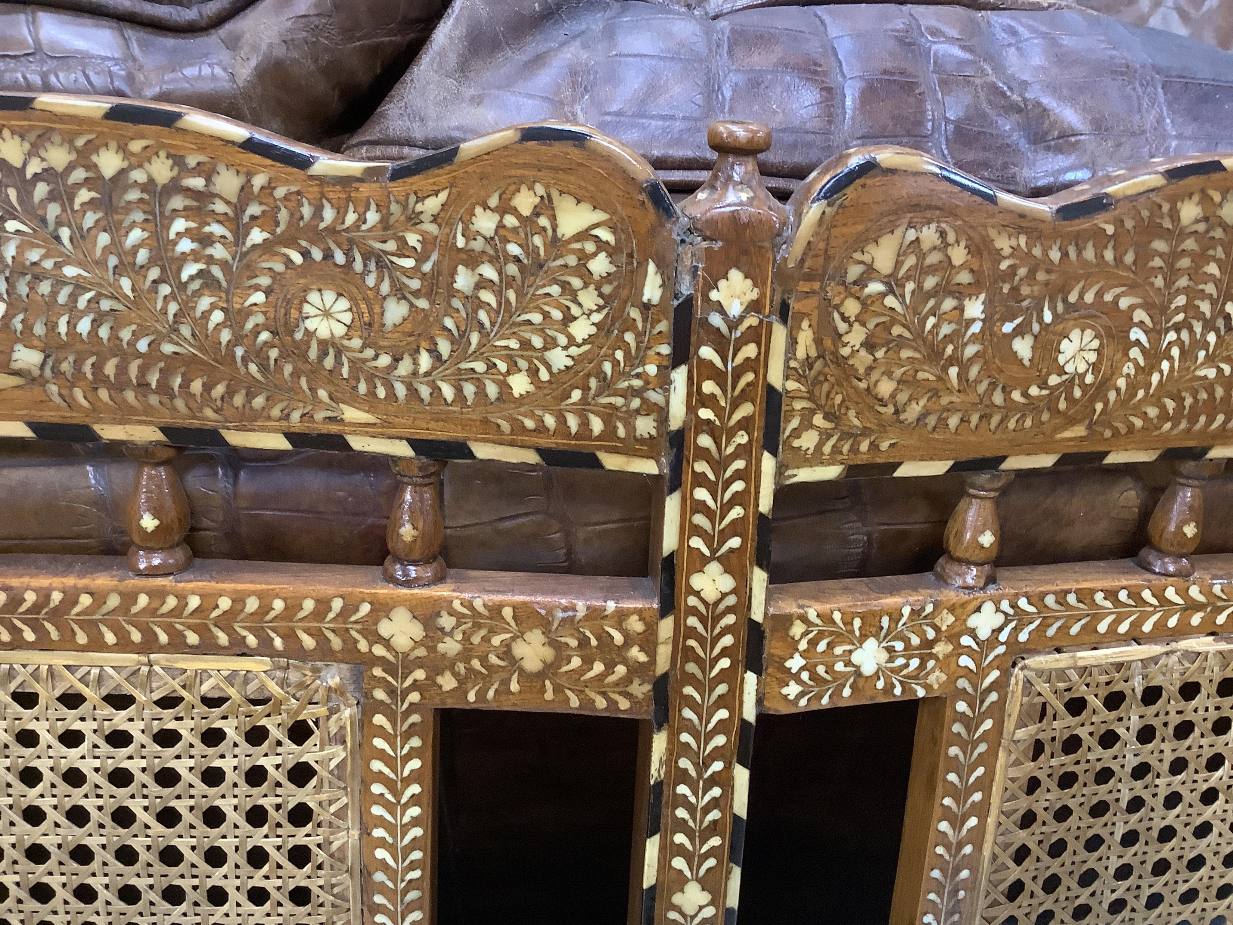 Hoshiarpur, a teak bone inlaid caned settee, width 107cm, depth 48cm, height 97cm. Condition - good